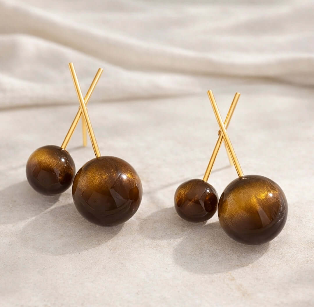 Détail des boules effet ambre en résine et des tiges finition dorée