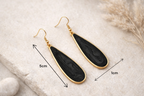 Boucles d’oreilles pendantes noir et or pour tenue chic de soirée